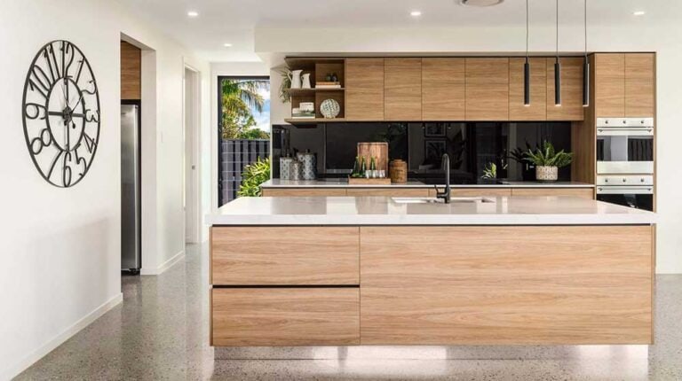 Contemporary kitchen with wooden cabinets, white countertops, and black backsplash in Zurich House, featuring sleek appliances and minimalist decor.