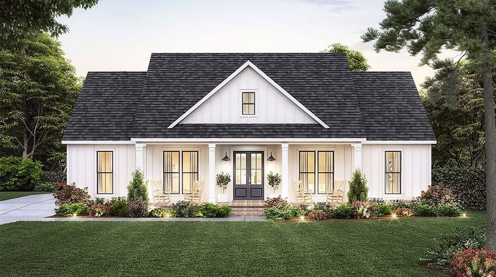 Cozy Modern Farmhouse with White Farmhouse Exterior, Gabled Roof, and Shuttered Windows, Surrounded by Lush Garden Landscaping, Perfect for Curb Appeal.