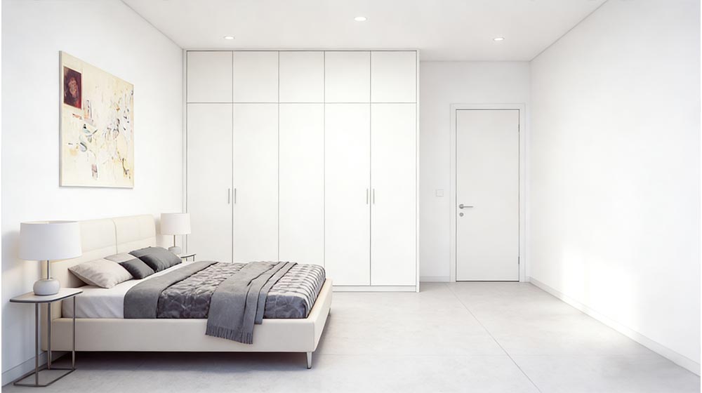 Bright minimalistic bedroom with sleek white furniture and simple decor, ideal for modern home interiors and relaxation.