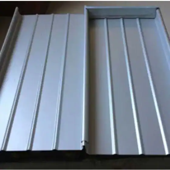Two silver metal roofing sheets with vertical ridges, placed side by side on a flat surface.