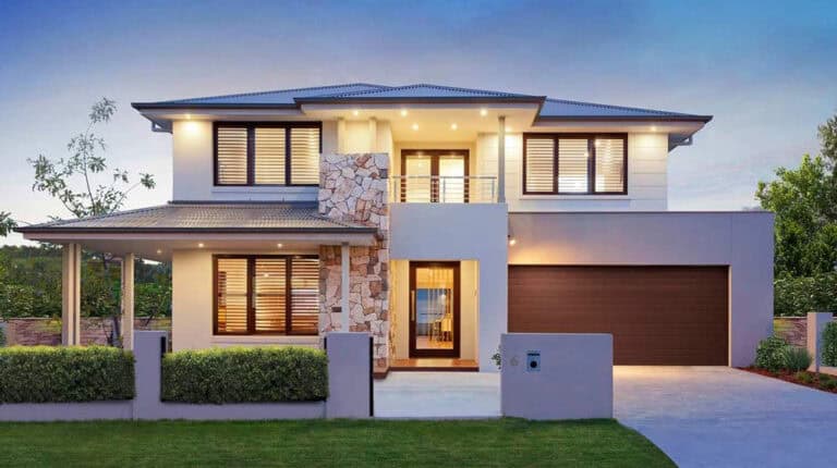 Modern two-story house with large windows, stone trim, double garage, and landscaped yard at sunset.
