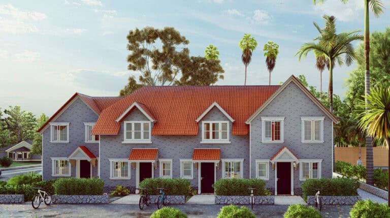 Modern townhouses with red-tiled roofs and gray walls amid greenery and palms; bicycles parked in front.