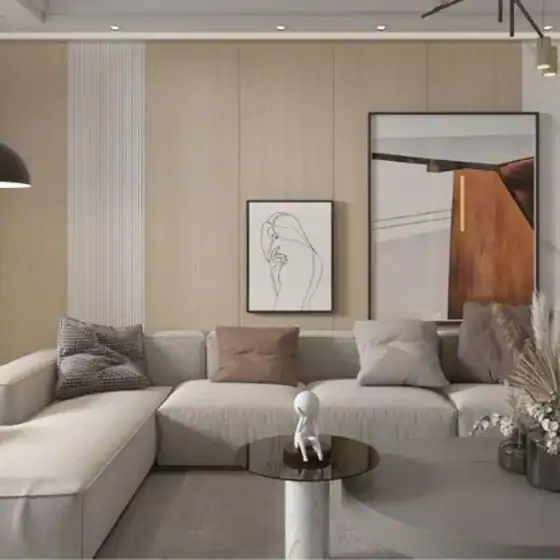 Modern living room with a gray sectional sofa, neutral pillows, abstract art, and a round coffee table with decor.