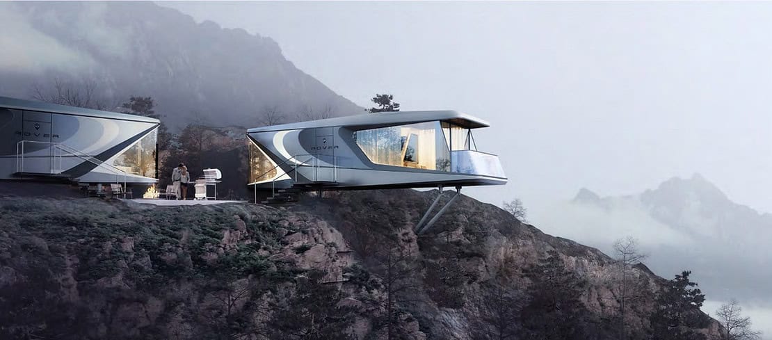 Two elevated modular homes on a misty, rocky mountainside; people stand on a deck next to one unit.