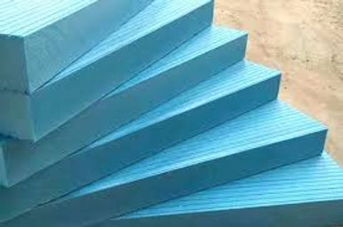 Blue foam boards are stacked in a step-like formation on a brown surface.