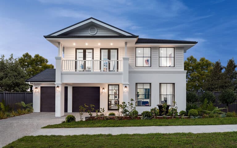 Modern two-story house with grey roof, white walls, double garage, balcony, large windows, and a small garden.