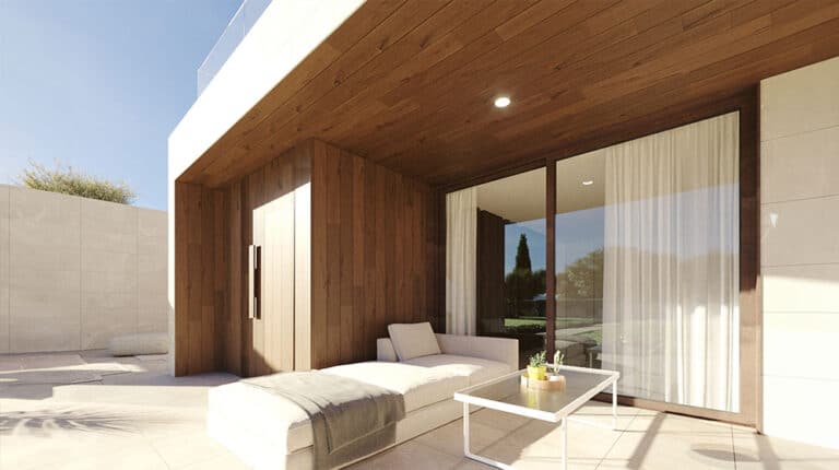 Outdoor patio with wooden ceiling, beige lounge chair, white coffee table, and glass doors with sheer curtains.