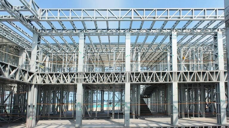 Steel building framework under construction, showing metal beams and support structures.