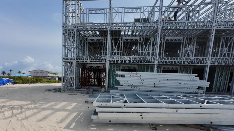Steel framing construction for a commercial building at a construction site on a sunny day.
