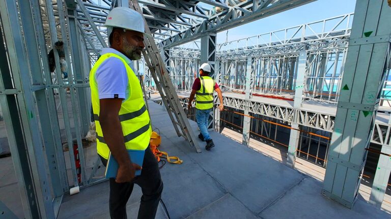 Steel construction workers at an active building site, emphasizing industrial construction and steel framing.