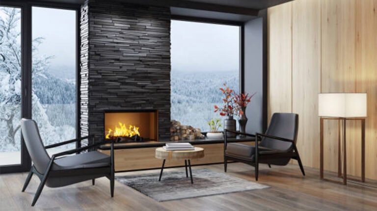 Cozy modern living room with fireplace, large window overlooking snowy landscape, stylish furniture, and natural wood accents. Perfect for winter relaxation and interior design inspiration.