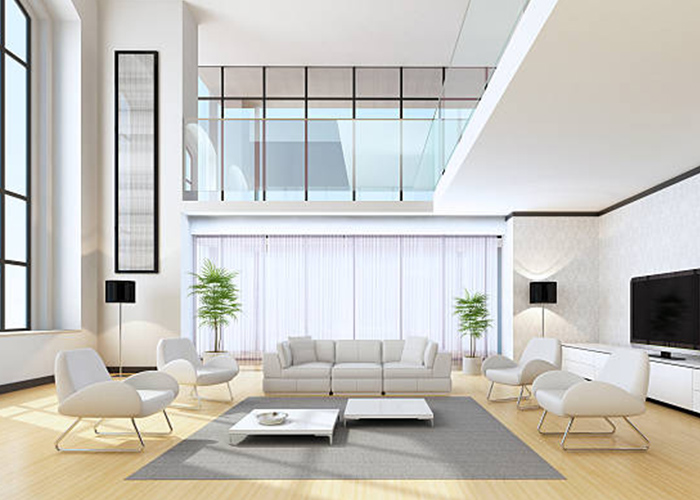 Modern minimalist living room with neutral-toned furniture and large windows, featuring a cozy sofa, stylish chairs, flat-screen TV, and indoor plants for a chic and airy home design.