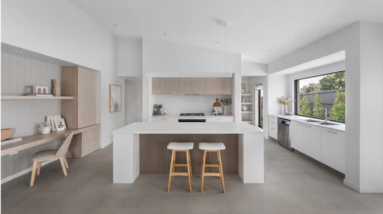 Bright modern white kitchen with natural wood accents, large window views, and minimalist design, perfect for contemporary home interiors.