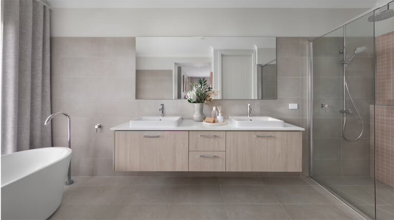 Modern bathroom with dual sinks, walk-in shower, freestanding bathtub, and neutral-toned tiles for a sleek, spa-like ambiance. Perfect for relaxation and contemporary home design.