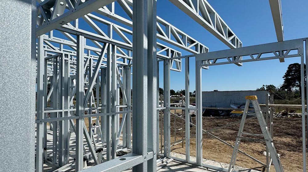 Steel framing structure under construction at a building site.