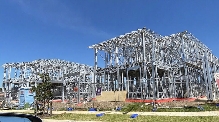 Modern steel-frame construction of a residential building under development, showcasing durable and innovative building materials by Deepblue for sustainable housing solutions.