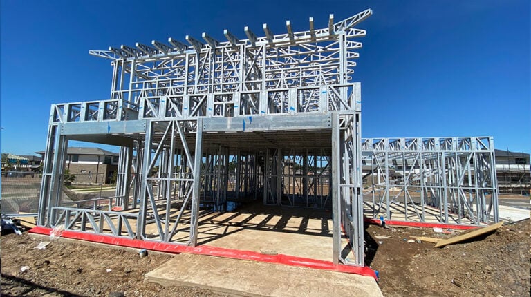 Steel residential building framework under construction with steel studs and structural elements, showcasing modern architectural steel framing.