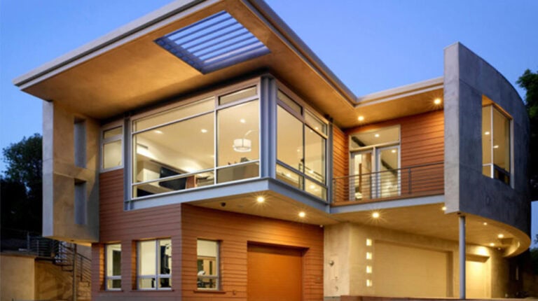 Contemporary modern house with large glass windows and sleek architectural design, featuring wood and concrete exterior, outdoor lighting, and a spacious balcony, emphasizing luxury and stylish living.