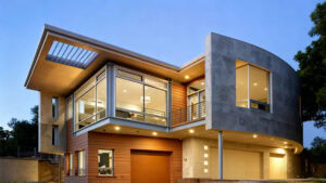 Casa contemporánea de dos pisos con grandes ventanales de vidrio, diseño moderno, exterior mixto de hormigón y madera, iluminada al anochecer, que muestra una arquitectura elegante y vida urbana.