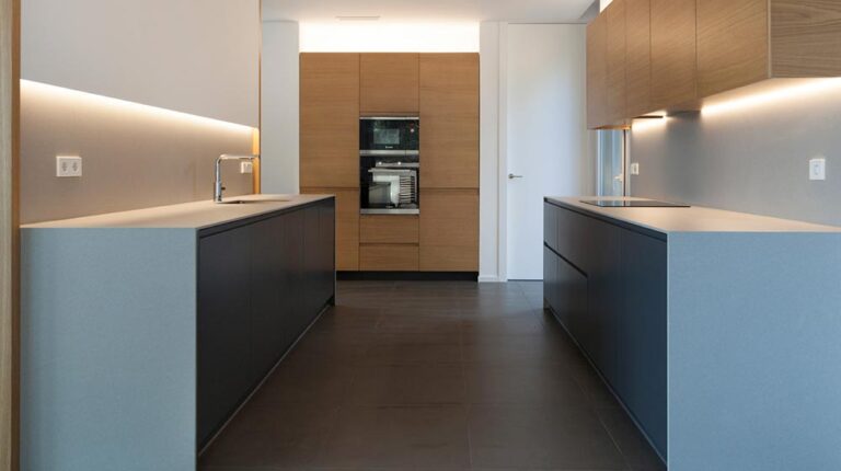Sleek modern kitchen with minimalistic design, wooden cabinetry, and built-in appliances for contemporary home aesthetics.