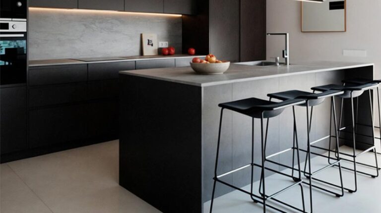 Premium modern kitchen with sleek black cabinetry, minimalist design, and a spacious island perfect for cooking and entertaining. Stylish black bar stools complement the contemporary ambiance.