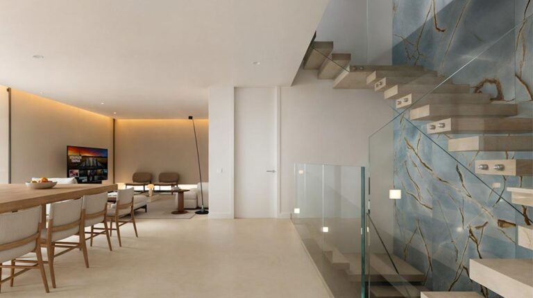 Luxurious modern living room with sleek decor, a staircase featuring marble accents, and minimalist furnishings, creating an elegant and contemporary home interior.