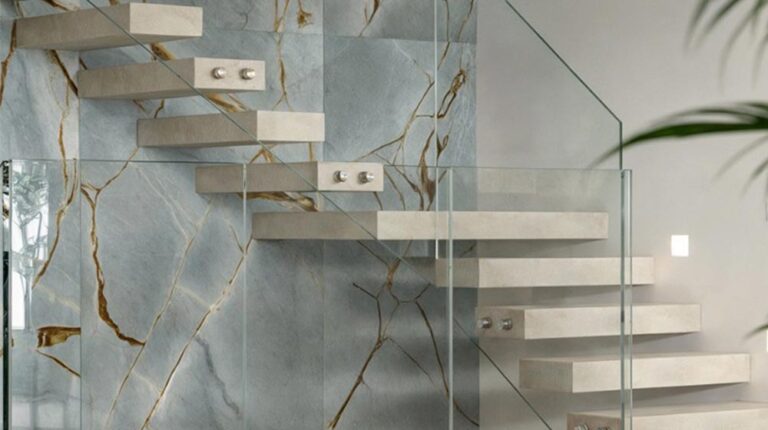 Contemporary floating stairs with marble steps and glass railing in modern home interior.
