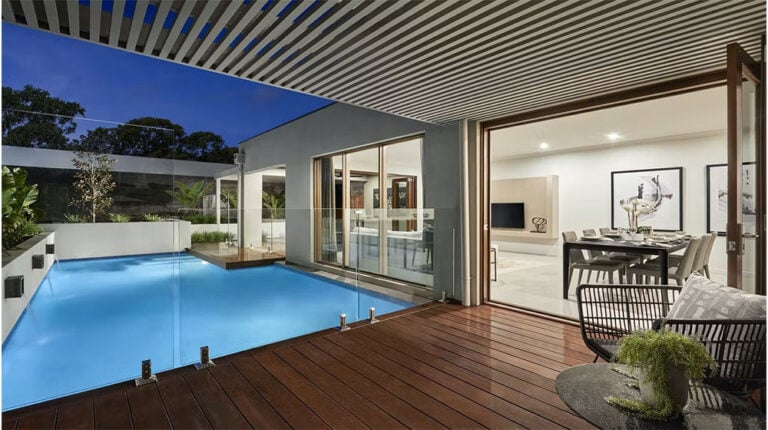 Elegant indoor and outdoor living with private pool, modern design, glass doors, and spacious patio for outdoor relaxation and entertainment.