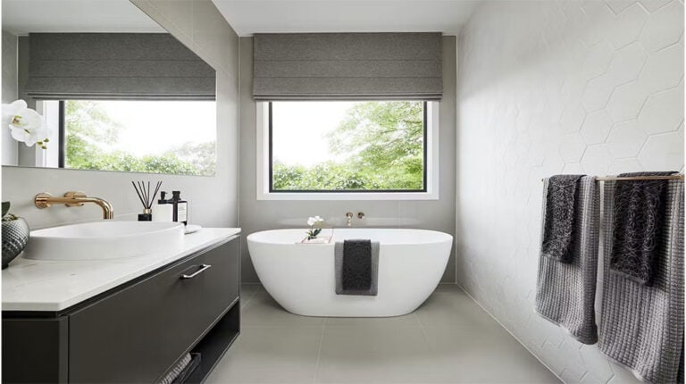 Luxurious freestanding bathtub with sleek vanity and natural light.