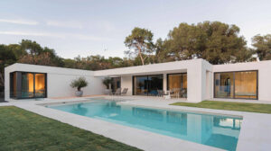 Stunning contemporary house with sleek design, large glass windows, and inviting outdoor pool for family relaxation and entertainment. Perfect for modern home living.