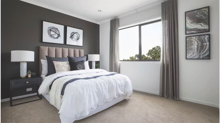 Bright, stylish bedroom featuring deep blue accents, contemporary artwork, and elegant furnishings, perfect for a cozy and sophisticated living space.