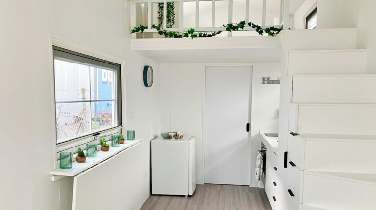 Bright, airy minimalist interior featuring white walls, modern cabinetry, and decorative greenery, creating a calming and stylish home environment.