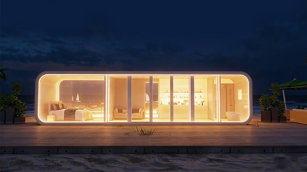 A sleek, illuminated tiny home located on the beach showcasing modern design, coastal elegance, and comfortable living space, ideal for upscale vacation or retreat.