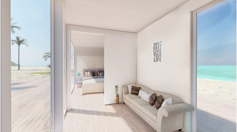 Ocean view beach house living room with large windows, white walls, cozy sofa, and serene coastal scenery, ideal for peaceful seaside living.