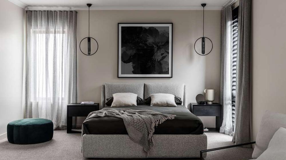 Bright, minimalist bedroom with neutral tones, stylish pendant lighting, and elegant decor for a relaxing sleep environment.