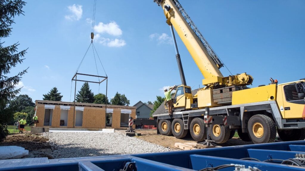 prefab house modules lifted by a crane