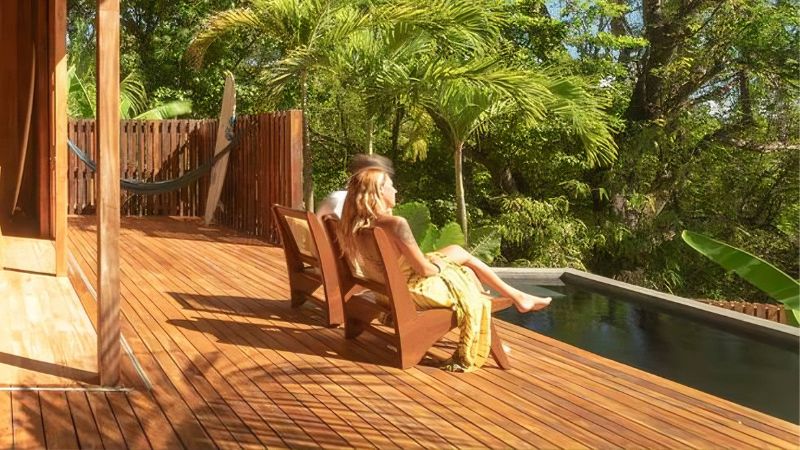 two persons sitting on bungalow porch, demonstrating its accessibility