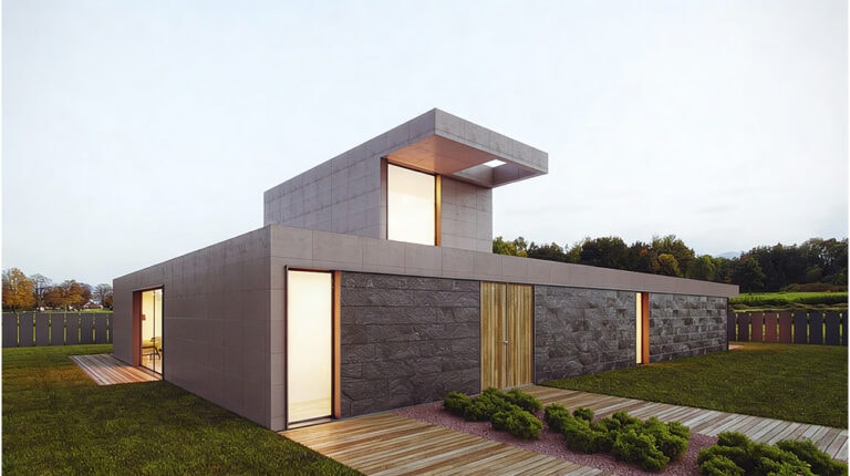 Modern minimalist house with geometric architecture, featuring large glass windows, a flat roof, and a combination of stone and wood exterior, set in a landscaped yard.