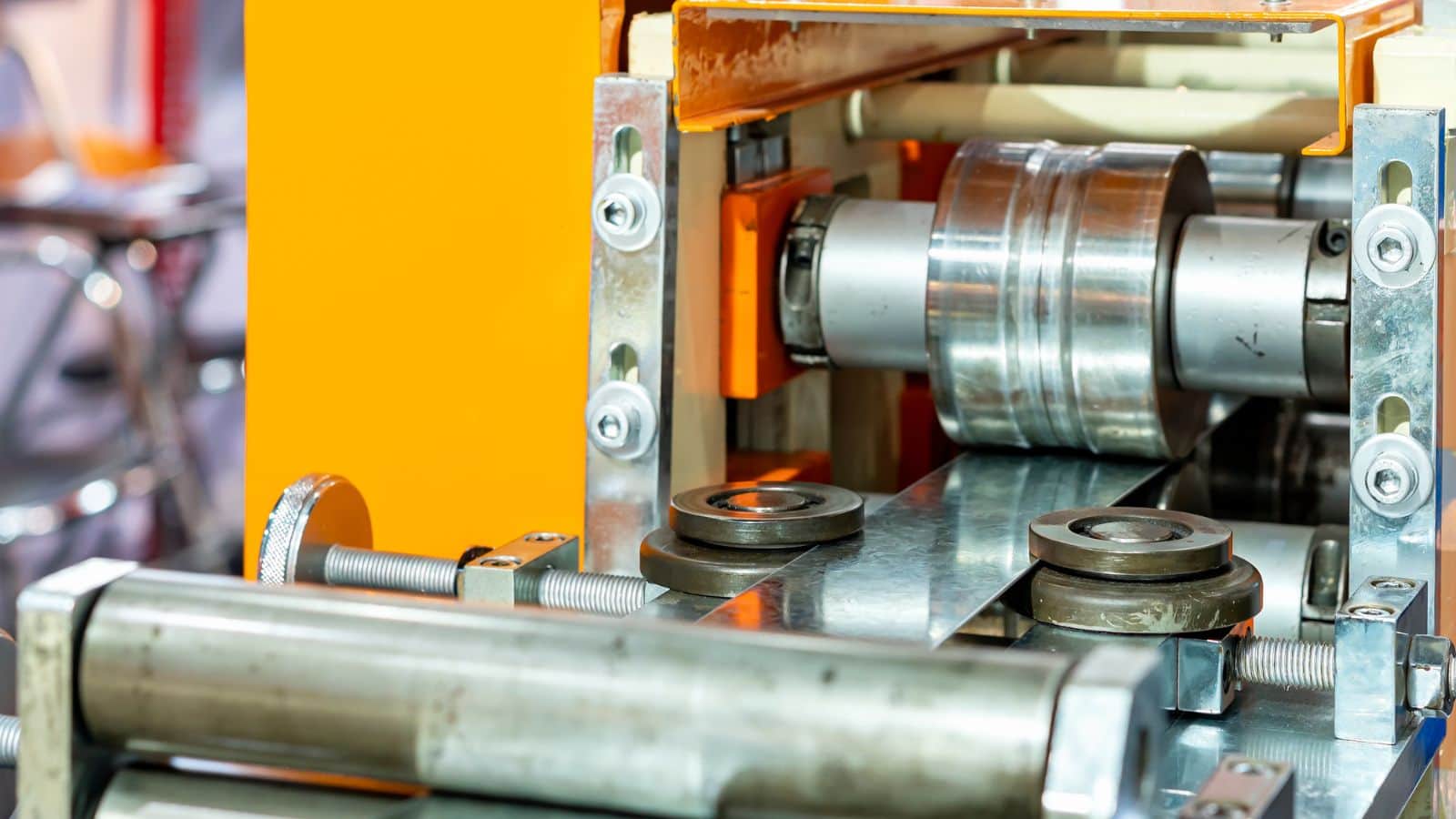 a roller machine that is processing steel bars into cold formed steel components