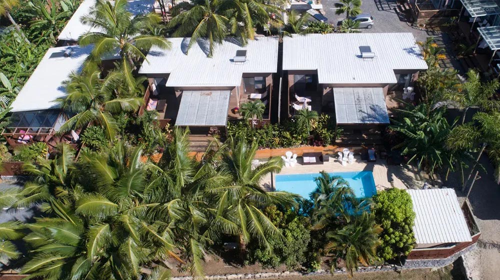 Elegant wooden bungalows surrounded by lush tropical greenery in the Cook Islands. Perfect for eco-friendly vacation stays with modern amenities and scenic ocean views.