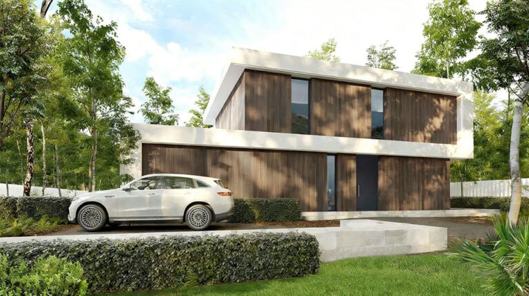 Contemporary Teurel House featuring a wooden exterior, large glass windows, and a sleek design, set amidst lush greenery with a driveway and a parked car.