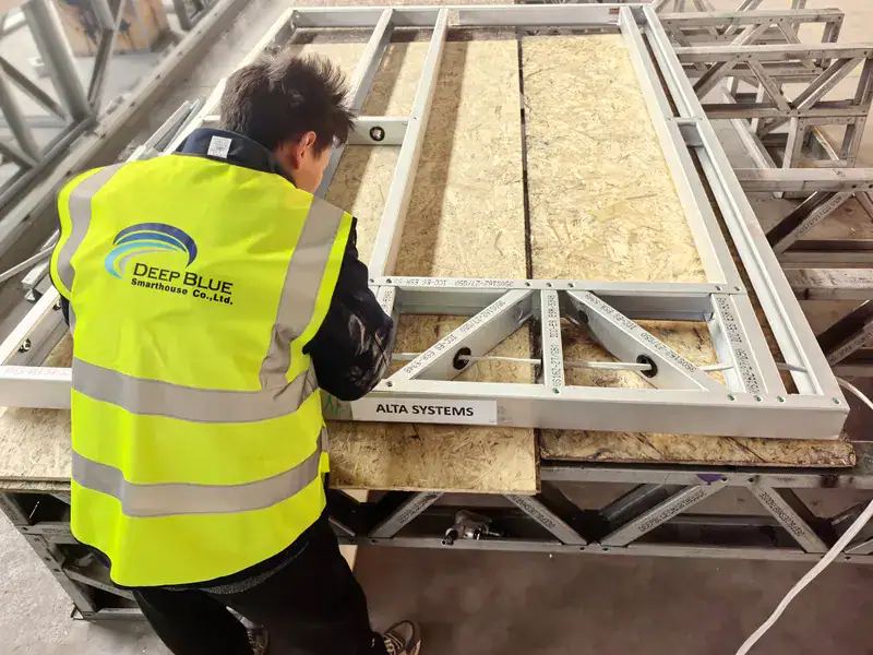 Construction worker in a high-visibility vest installing a structural frame on a building site, showcasing advanced construction techniques and safety measures.