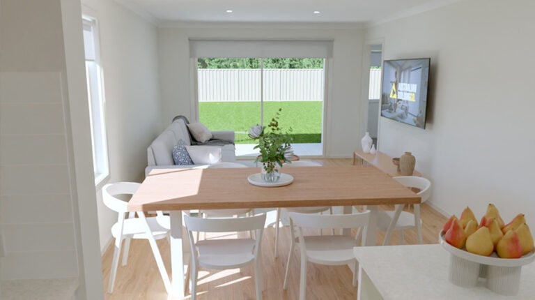 Bright and airy living room featuring a large window with a view of a green backyard, a cozy sofa, and a wall-mounted TV, creating a welcoming space for relaxation and family gatherings.
