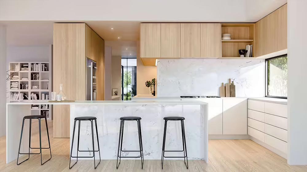 Modern minimalist kitchen featuring a sleek marble island, light wood cabinets, and ample natural light, perfect for contemporary home design and culinary spaces.