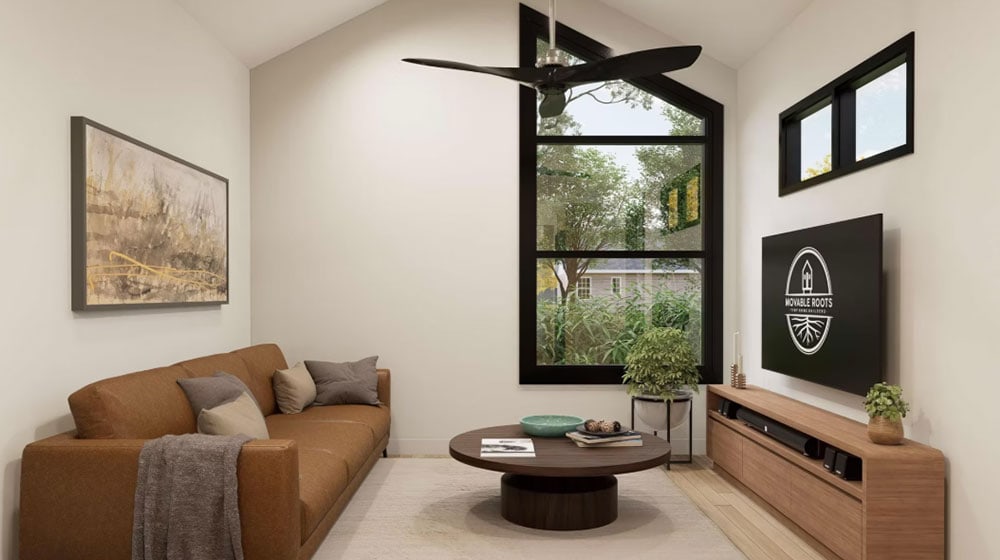 Bright and airy living room featuring large black-framed windows, a stylish ceiling fan, a brown sofa with cushions, and contemporary decor, creating a cozy and inviting atmosphere.