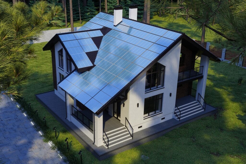 Modern house equipped with extensive solar panels on the roof, showcasing sustainable energy solutions in a lush green environment.