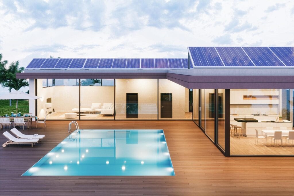 Solar-powered modern home with a sleek design, large glass walls, and a swimming pool, showcasing sustainable architecture and outdoor living space.