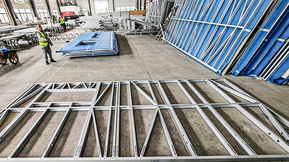 Steel framing components for the Deepblue panelized system in a manufacturing facility, ready for assembly.