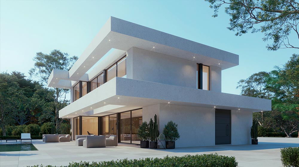 Modern white two-story house with expansive glass windows, outdoor seating, and lush greenery, showcasing contemporary architecture and outdoor living space.