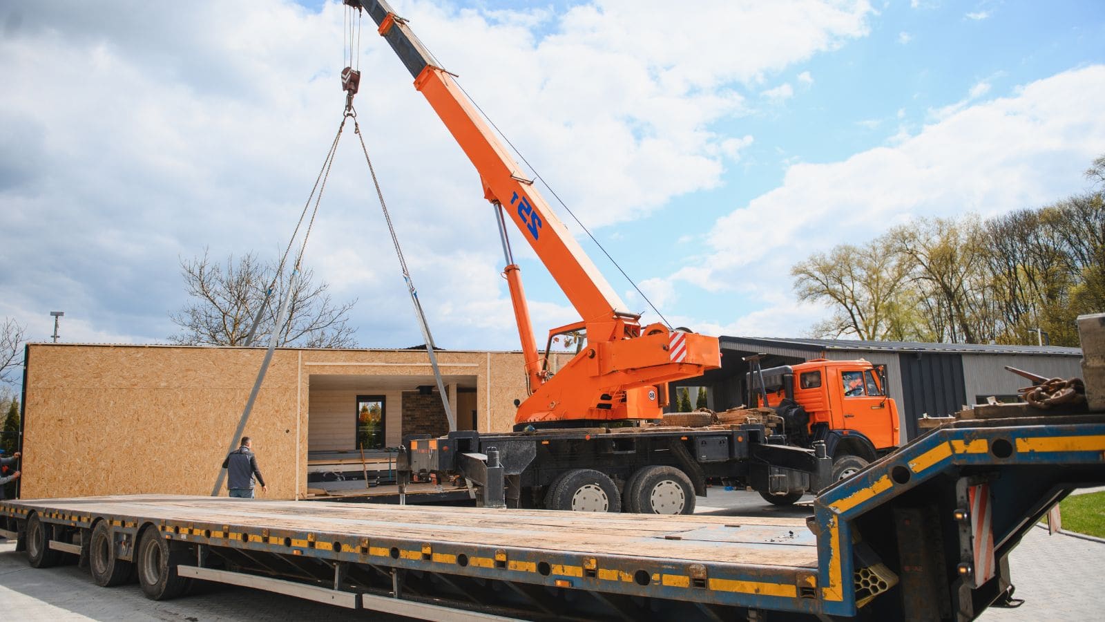 a crane at the worksite for a prefab bathroom transport